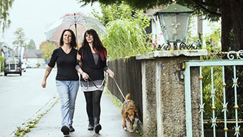 consumer with ostomy walking dog