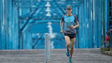 man running on a bridge