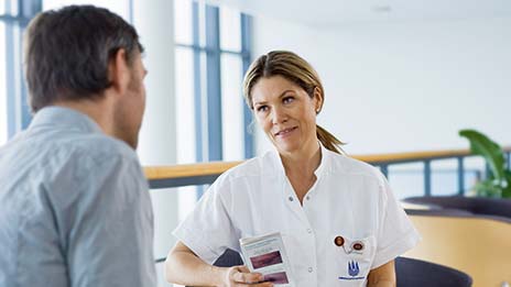 Nurse taking to a patient about living with a stoma 