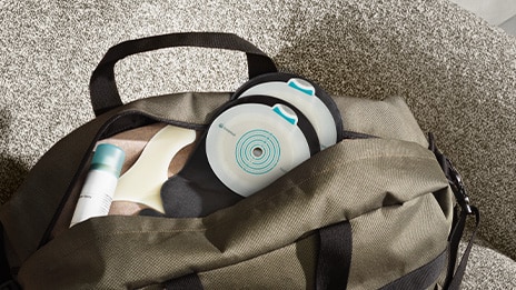 SenSura Mio Black ostomy bag is placed in a green gym bag.